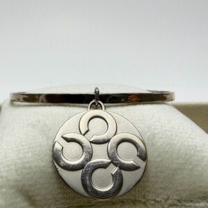 Chic COACH Silver Bangle with Circular Pendant